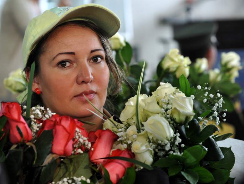 Una mujer muestra ramos de rosas durante un evento con el presidente colombiano Juan Manuel Santos (fuera del marco) para conmemorar el Día Internacional de la Mujer el 8 de marzo de 2011