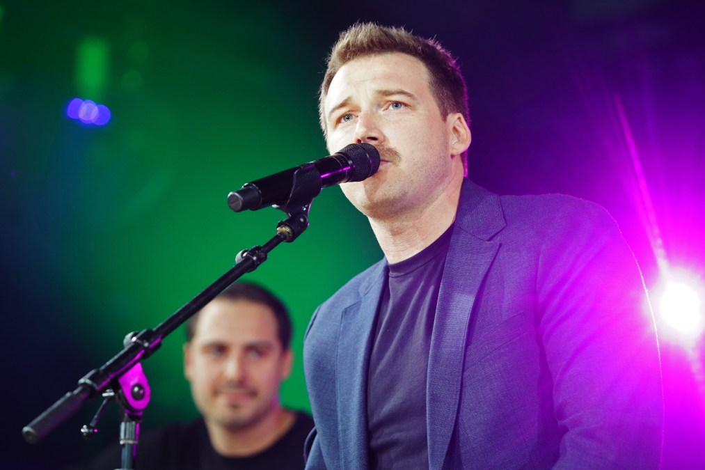 Morgan Wallen singing into a microphone