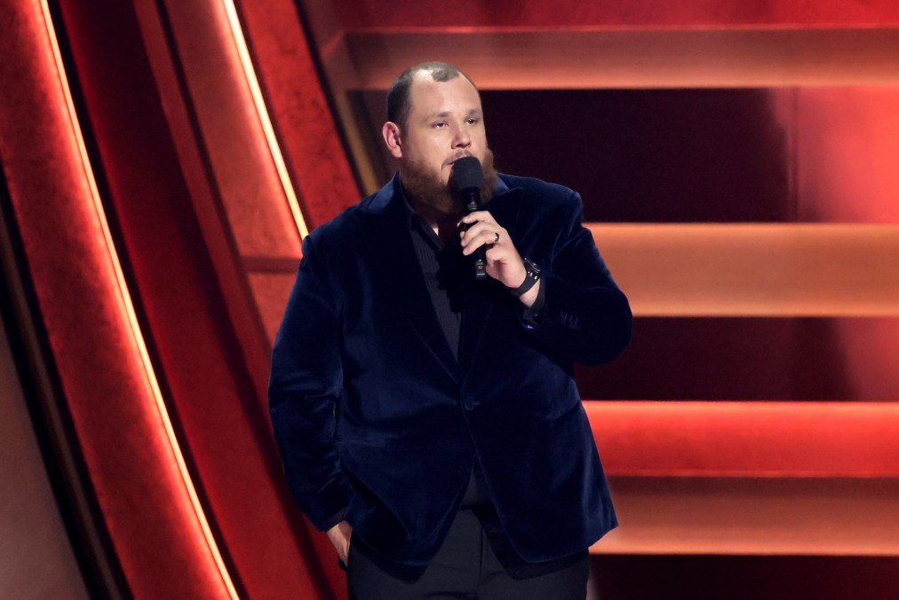 Luke Combs speaking into a microphone