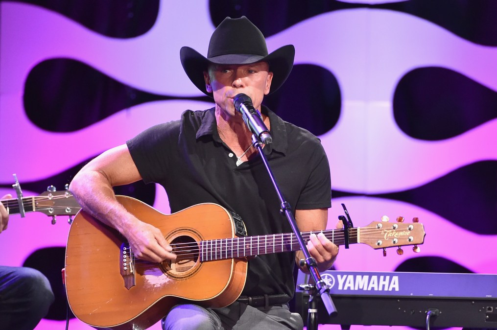 Kenny Chesney singing and playing guitar