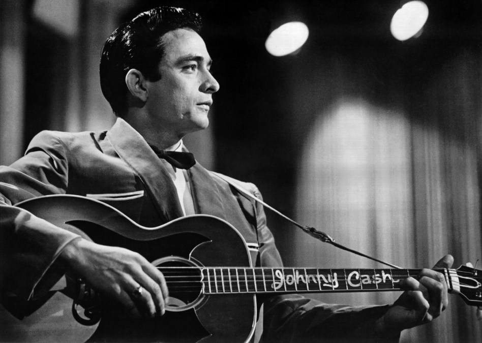 Johnny Cash playing acoustic guitar