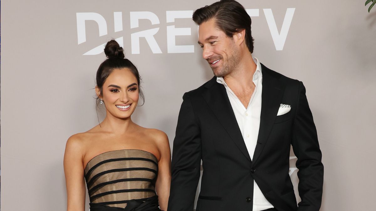 Craig Conover looks at Paige DeSorbo as they pose on the red carpet