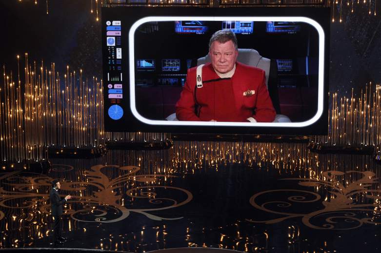 Seth MacFarlane talks to actor William Shatner on the video screen during the Oscars