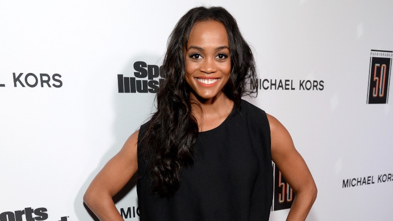 Rachel Lindsay stands with her hands on her hips.