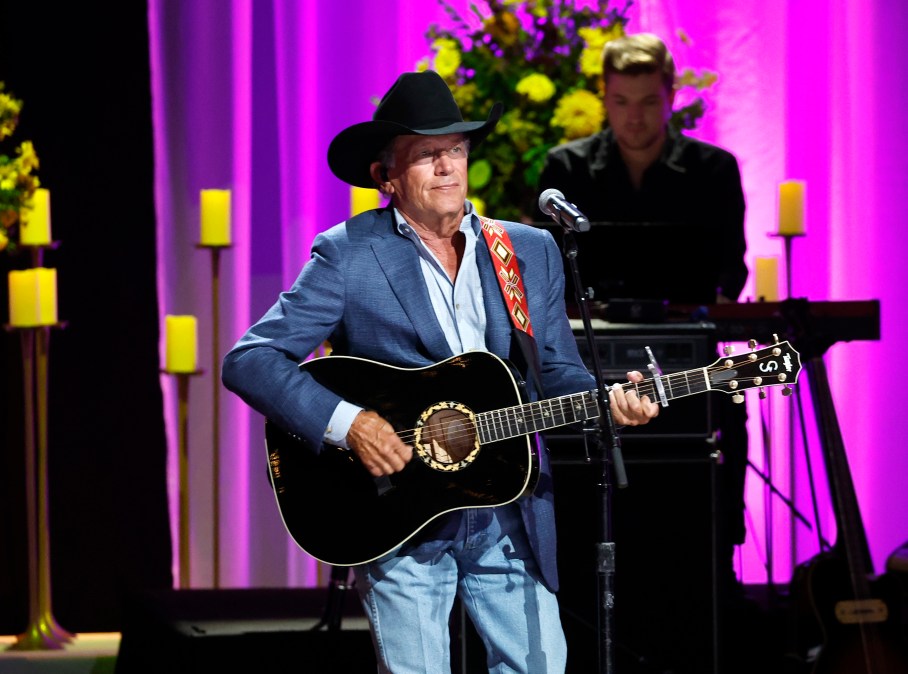 George Strait playing a guitar