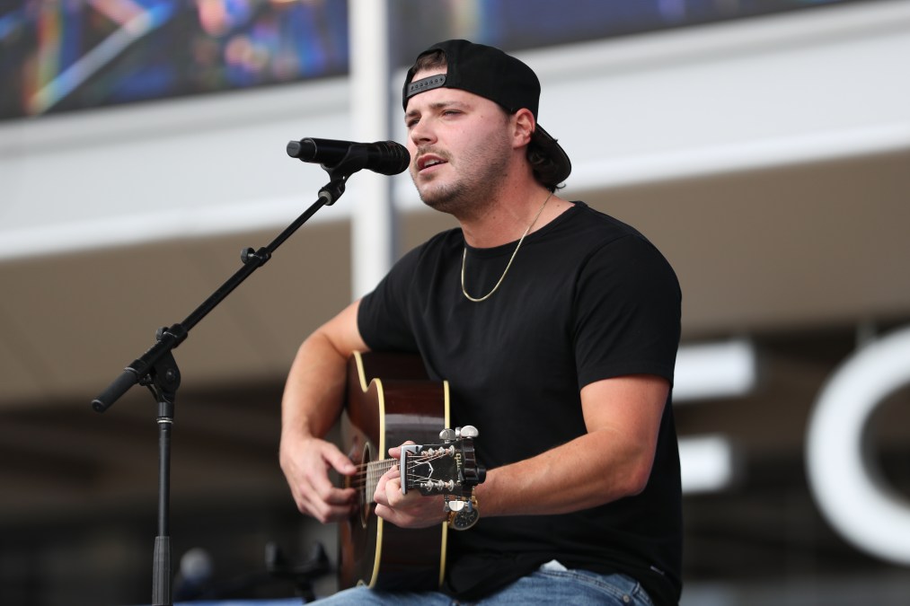 Josh Ross playing guitar and singing