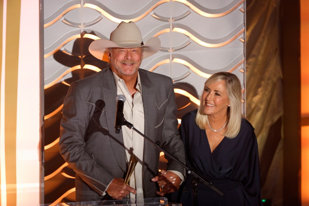 Alan Jackson smiling next to his wife