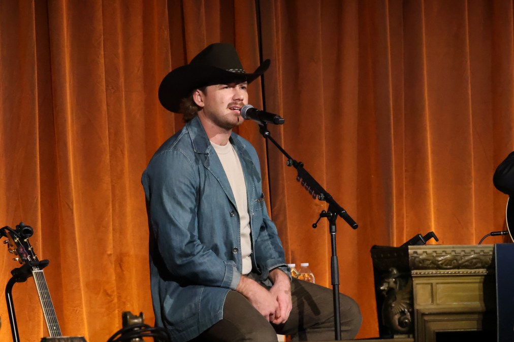 Morgan Wallen singing into a microphone