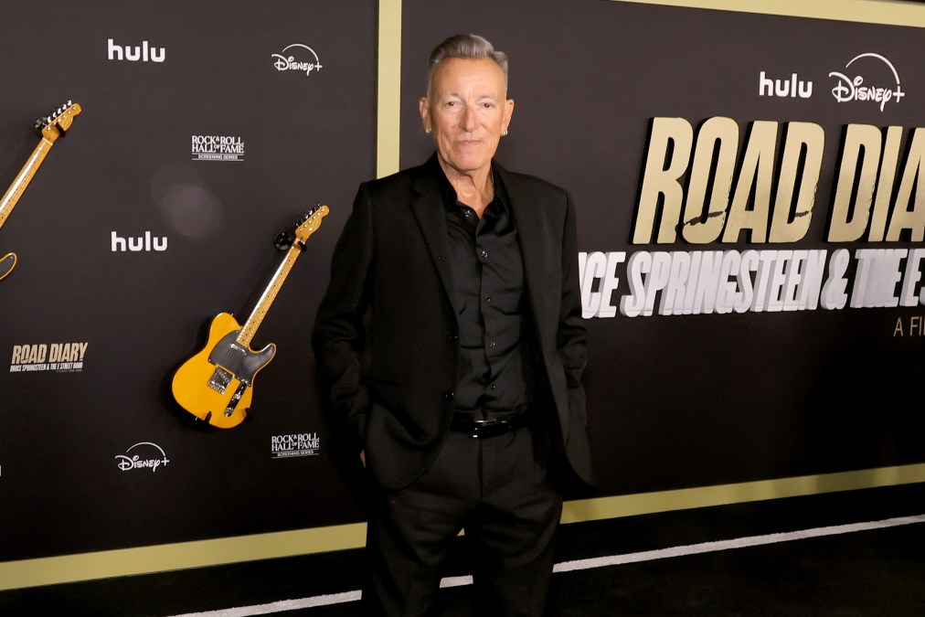 Bruce Springsteen posing in front of a step and repeat