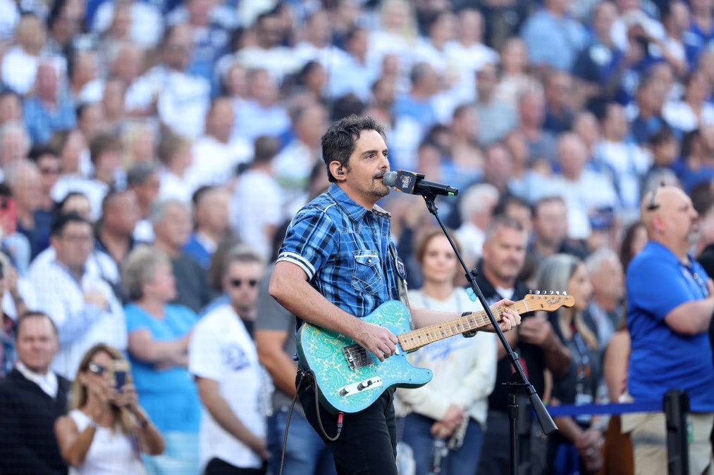 Brad Paisley playing guitar in front of a crowd