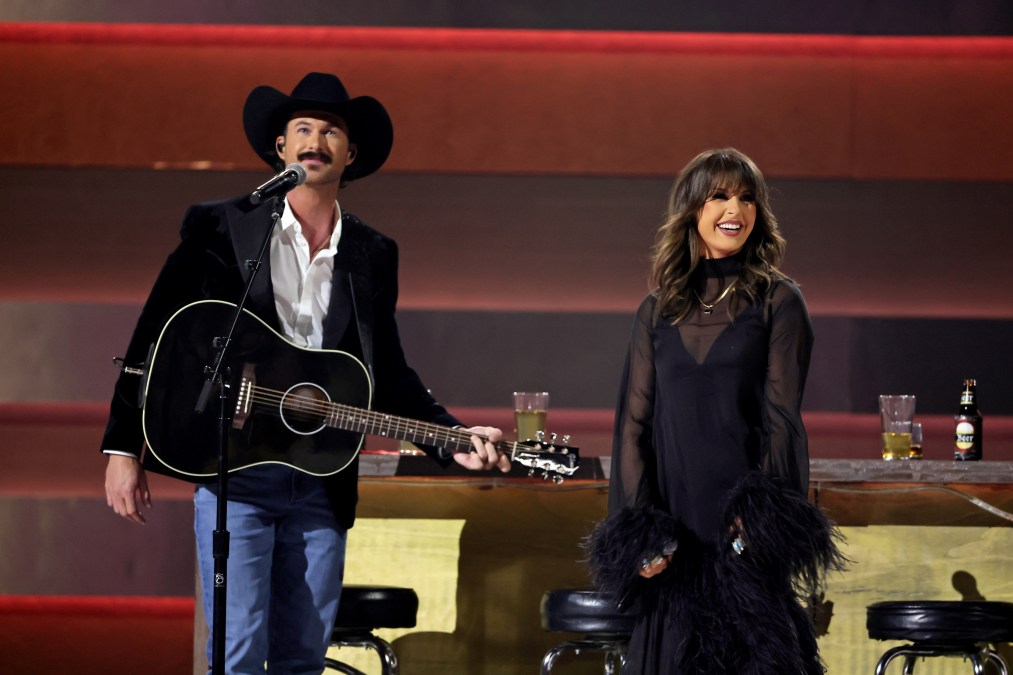 Ella Langley and Riley Green smiling on stage