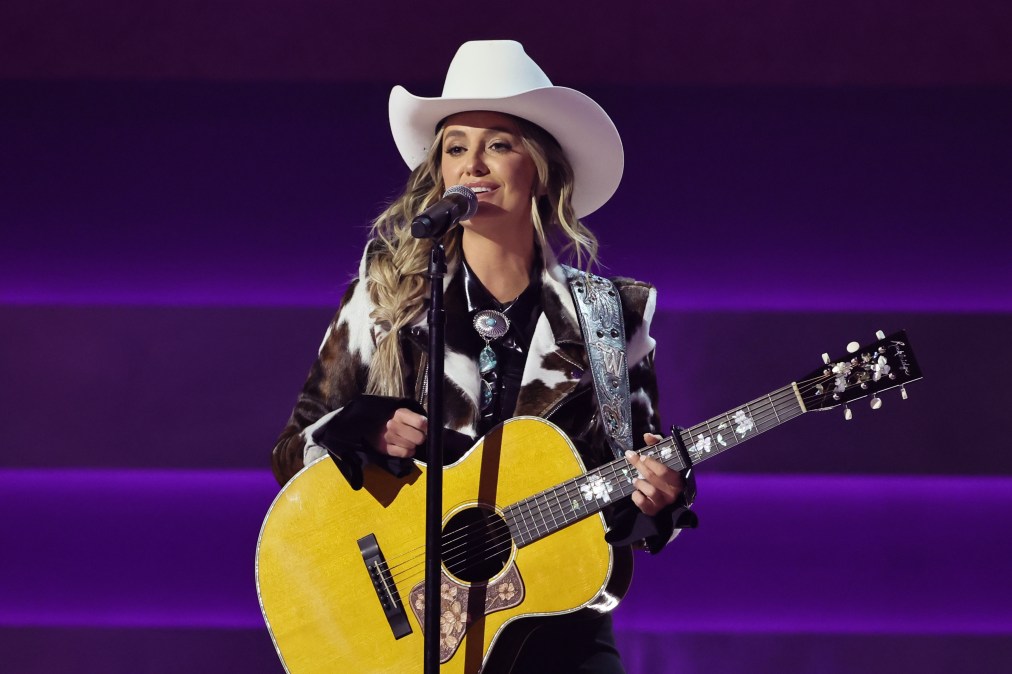 Lainey Wilson holding a guitar