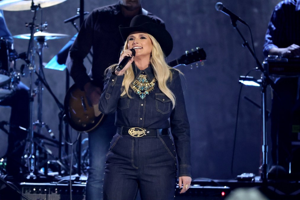 Miranda Lambert singing in a denim jumpsuit