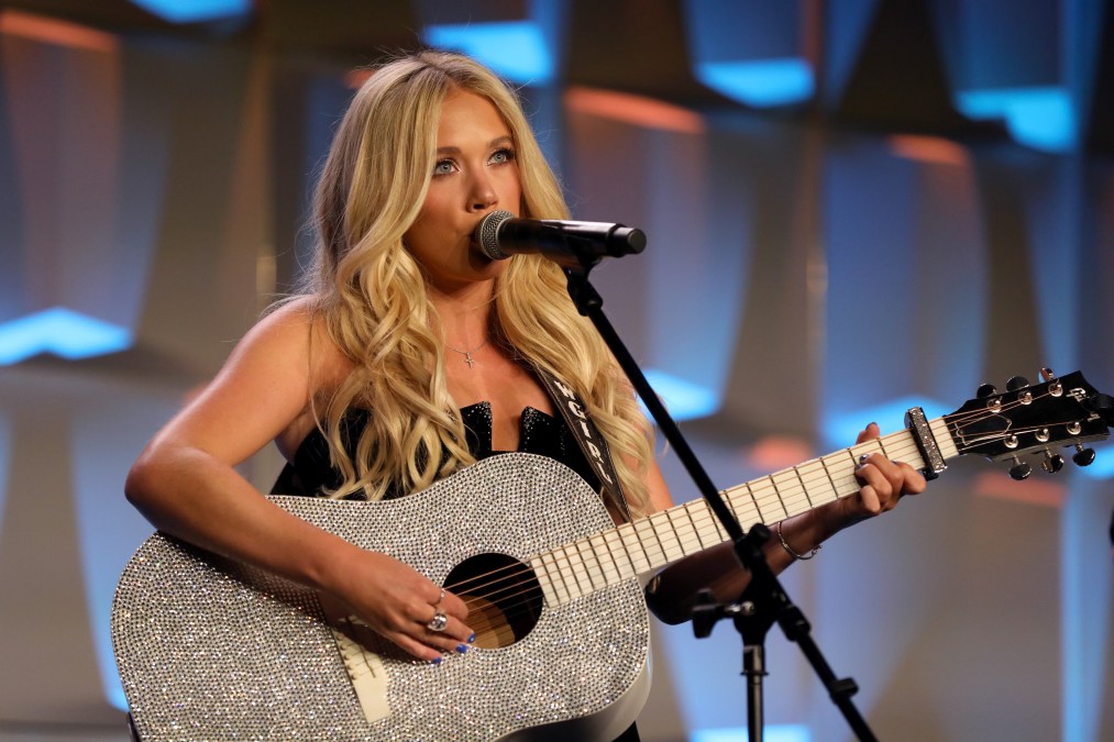 Megan Moroney playing guitar