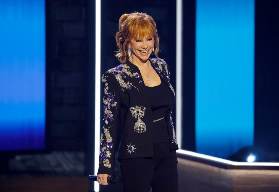 Reba McEntire smiling while on stage