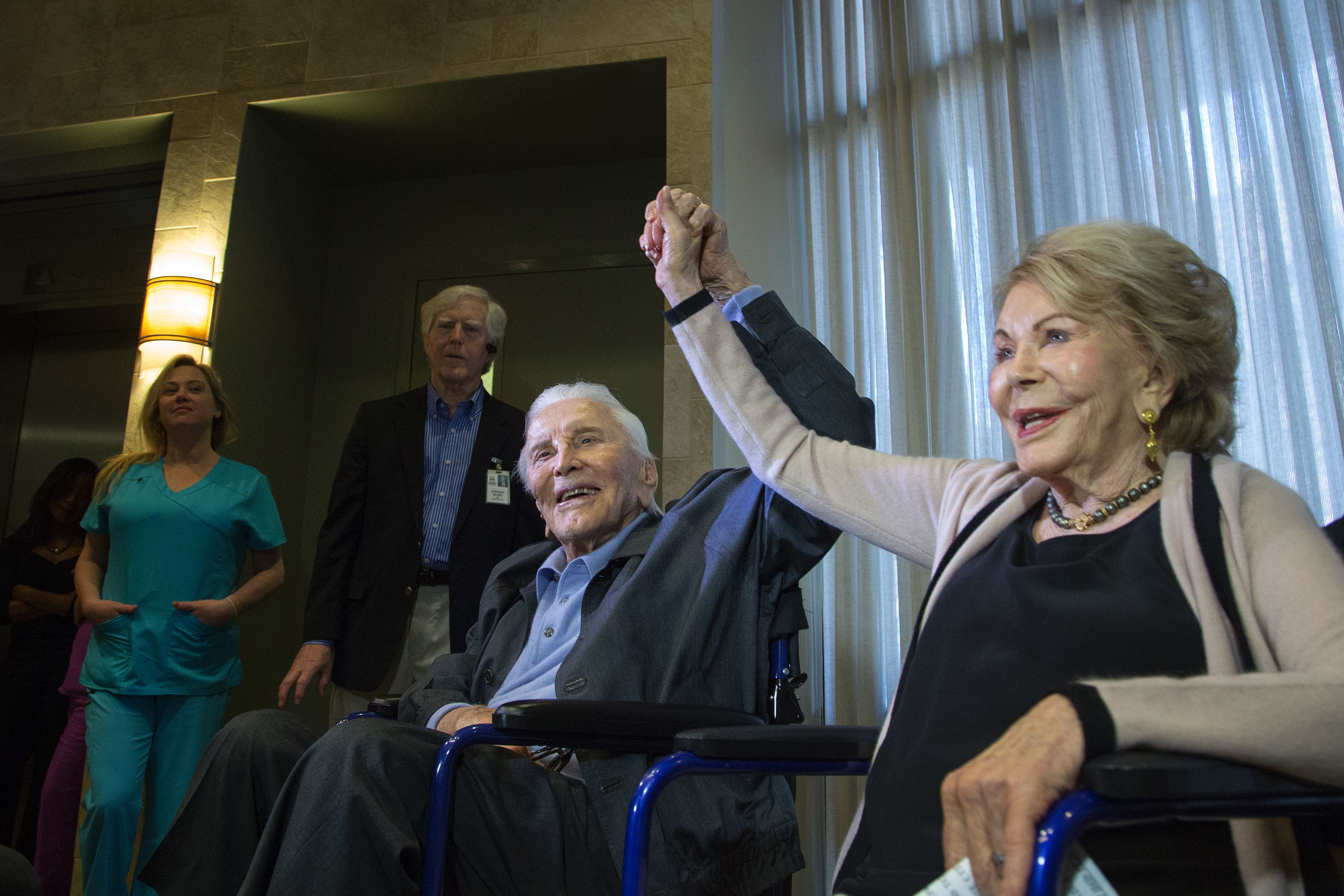 Kirk Douglas and Wife Anne Buydens Holding Hands